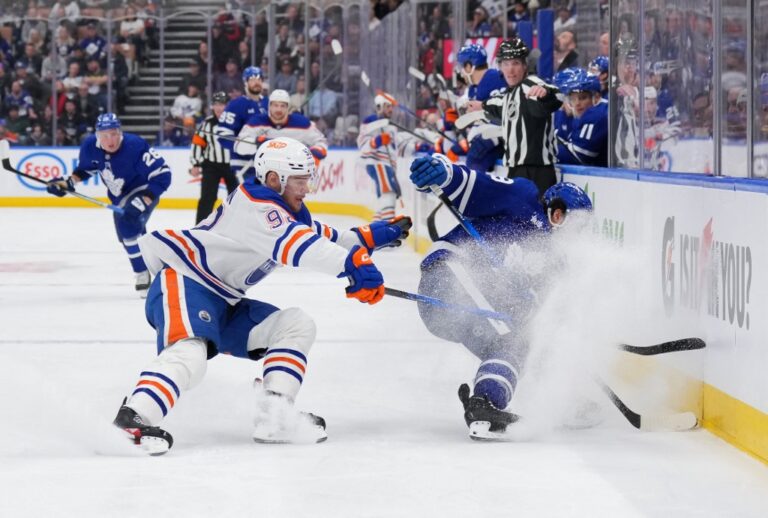 The cover for this NHL parlays today article shows Vasily Podkolzin #92 of the Edmonton Oilers battling for the puck with Nicholas Robertson #89 of the Toronto Maple Leafs.