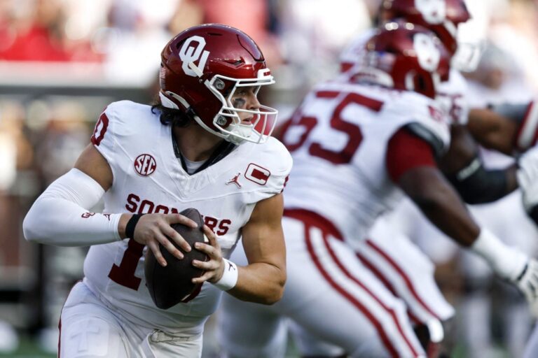 John Mateer #10 of the Oklahoma Sooners rolls out to pass during the first quarter of a football game against the Alabama Crimson Tide.