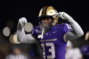 Tyler Brown #13 of the James Madison Dukes celebrates a tackle against the Troy Trojans.