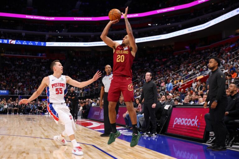 Jaylon Tyson #20 of the Cleveland Cavaliers takes a second half shot over Duncan Robinson #55 of the Detroit Pistons.