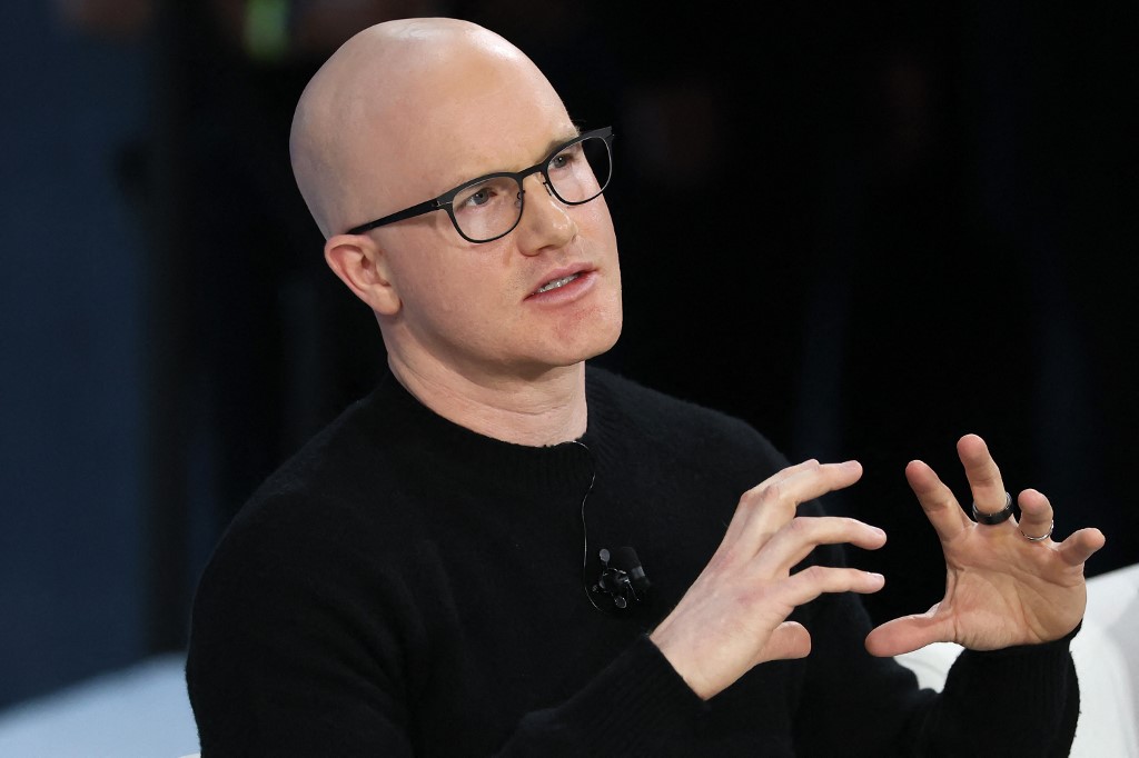 The cover for this article shows Coinbase CEO Brian Armstrong speaks onstage during the 2025 New York Times Dealbook Summit