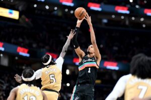 The cover for this NBA player props today article shows Victor Wembanyama #1 of the San Antonio Spurs shooting the ball in the third quarter against Jamir Watkins #5 of the Washington Wizards.