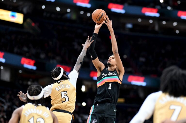 The cover for this NBA player props today article shows Victor Wembanyama #1 of the San Antonio Spurs shooting the ball in the third quarter against Jamir Watkins #5 of the Washington Wizards.