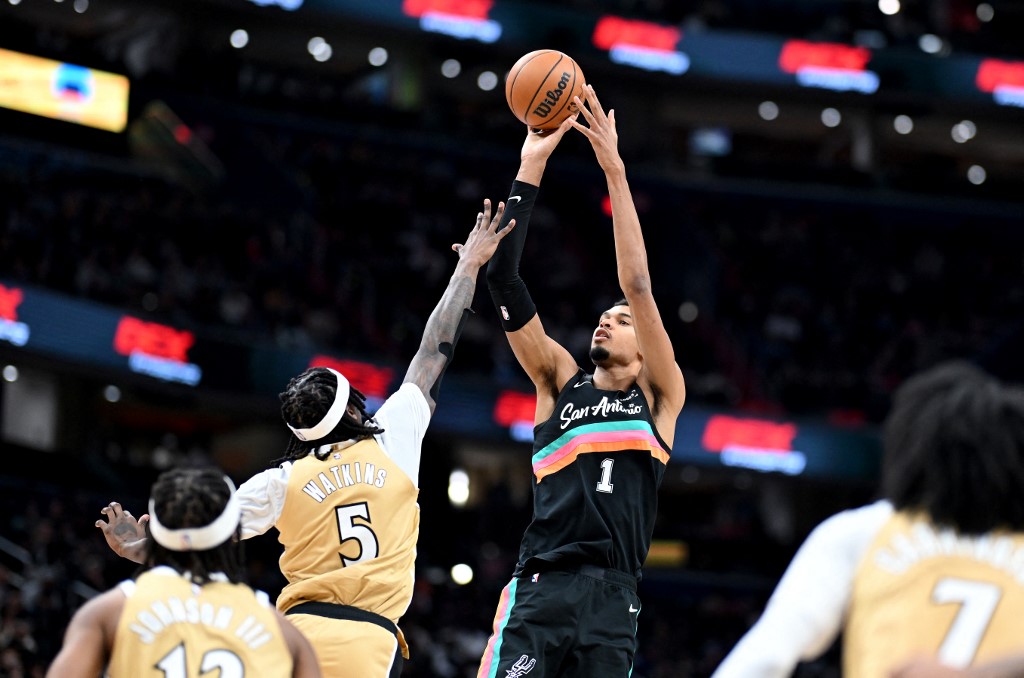 The cover for this NBA player props today article shows Victor Wembanyama #1 of the San Antonio Spurs shooting the ball in the third quarter against Jamir Watkins #5 of the Washington Wizards.