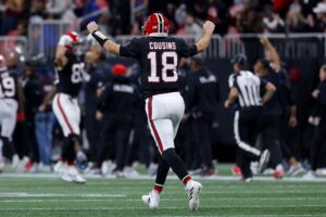 Kirk Cousins #18 of the Atlanta Falcons celebrates a touchdown by Bijan Robinson #7 (not pictured) against the Los Angeles Rams.