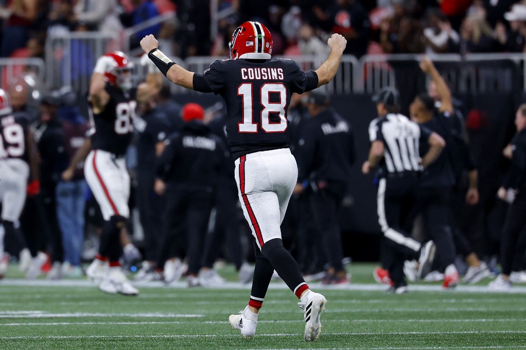 Kirk Cousins #18 of the Atlanta Falcons celebrates a touchdown by Bijan Robinson #7 (not pictured) against the Los Angeles Rams.