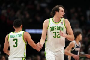 Nate Bittle #32 of the Oregon Ducks high fives teammate Jackson Shelstad #3 during the first half against the Gonzaga Bulldogs.
