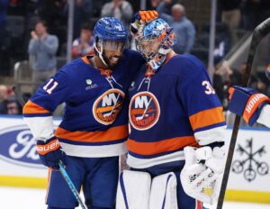 Anthony Duclair #11 of the New York Islanders congratulates Ilya Sorokin #30 during a game against the New Jersey Devils.