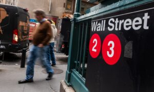 People walk by the New York Stock Exchange (NYSE) in New York City