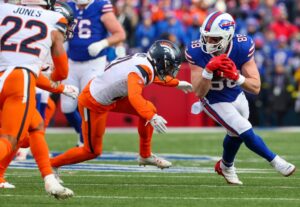 The cover for this Sunday wild card picks article shows Dawson Knox #88 of the Buffalo Bills carrying the ball against the Denver Broncos