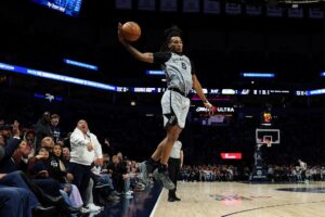 Stephon Castle #5 of the San Antonio Spurs receives a pass against the Minnesota Timberwolves.