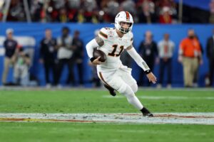 Carson Beck #11 of the Miami Hurricanes runs the ball against the Ole Miss Rebels.