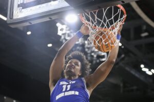 Kenny Pohto #11 of the UC Santa Barbara Gauchos dunks the ball in the first half of a semifinal game of the Big West mens basketball tournament against the UC San Diego Tritons.