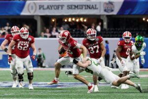 Fernando Mendoza #15 of the Indiana Hoosiers is tackled by Bryce Boettcher #28 of the Oregon Ducks.