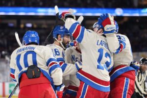 Artemi Panarin #10 of the New York Rangers is congratulated by his teammates after scoring a goal against the Florida Panthers.