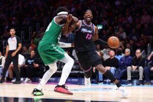 The cover for this NBA player props today article shows Bam Adebayo #13 of the Miami Heat making a move against Neemias Queta #88 of the Boston Celtics