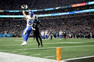 The cover for this NFL championship round player props article shows Colby Parkinson #84 of the Los Angeles Rams catching a 19 yard touchdown pass against Tre'von Moehrig #7 of the Carolina Panthers.