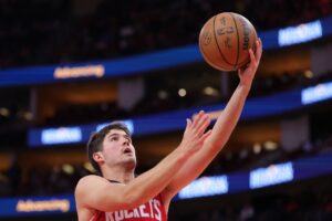 Reed Sheppard #15 of the Houston Rockets shoots the ball against the Orlando Magic.