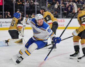 The cover for this NHL picks today article shows Jake Neighbours #63 of the St. Louis Blues celebrating his third-period power-play goal against the Vegas Golden Knights.