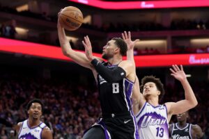 Zach Lavine #8 of the Sacramento Kings goes up for a shot on Walter Clayton Jr. #13 of the Utah Jazz.
