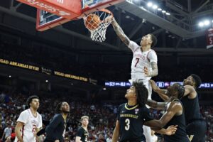 The cover for this college basketball picks today article shows Trevon Brazile #7 of the Arkansas Razorbacks dunking the ball in the second half during the game against the Vanderbilt Commodores.