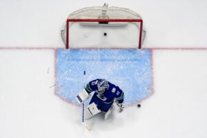 The cover for this NHL picks today article shows Kevin Lankinen #32 of the Vancouver Canucks tending the net against the the Pittsburgh Penguins during the second period of their NHL game.