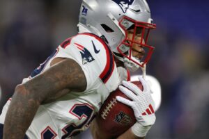 Treveyon Henderson #32 of the New England Patriots warms up before the game against the Baltimore Ravens.
