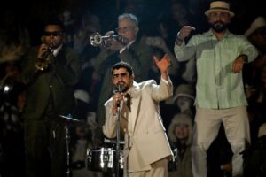 The cover for this NFL Halftime Show props for Super Bowl article shows Puerto Rican rapper Bad Bunny performing on stage.