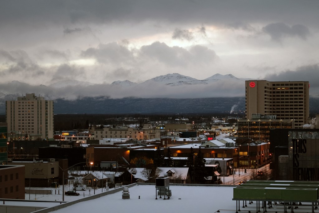 A mountain range stands above downtown in Anchorage, Alaska.