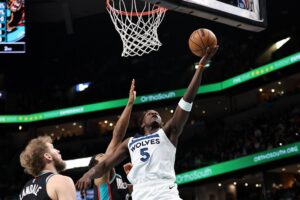 Anthony Edwards #5 of the Minnesota Timberwolves drives to the basket against Jaylen Wells #0 of the Memphis Grizzlies.