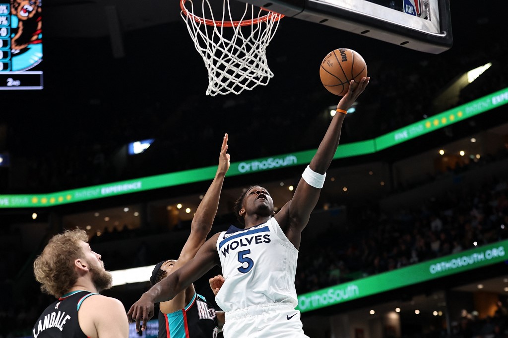 Anthony Edwards #5 of the Minnesota Timberwolves drives to the basket against Jaylen Wells #0 of the Memphis Grizzlies.