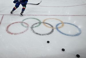 Olympic rings adorn the ice rink as players warm up prior to the an Ice Hockey match during the Milano Cortina 2026 Winter Olympic Games.
