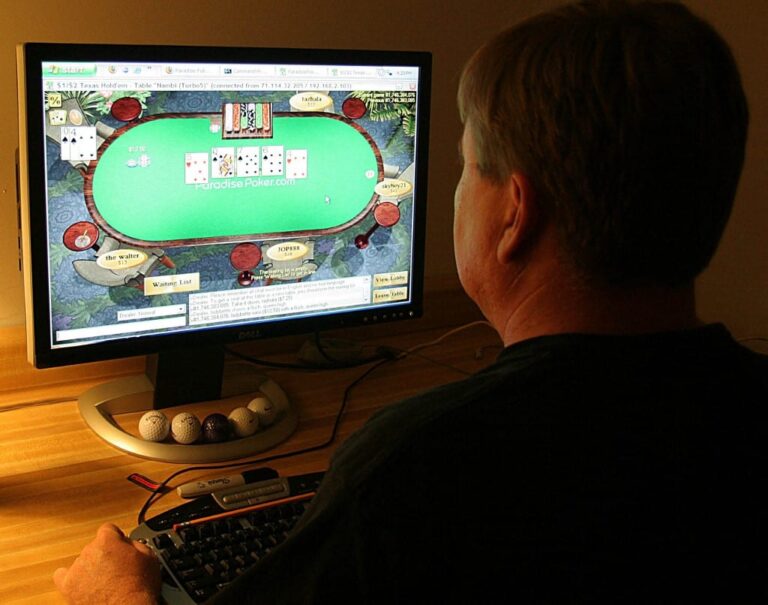 A man plays poker on his computer connected to an internet gaming site.